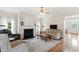 Inviting living room with a fireplace, comfortable seating, and natural light pouring through the large windows at 1001 Pasture View Ln, Raleigh, NC 27603