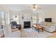 Bright living room featuring a fireplace, comfortable seating, and large windows providing natural light at 1001 Pasture View Ln, Raleigh, NC 27603