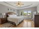 Main bedroom with hardwood floors, ceiling fan, and natural light from three large windows at 1001 Pasture View Ln, Raleigh, NC 27603