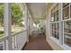 Relaxing porch with white wicker seating, offering a tranquil outdoor space to unwind and enjoy views at 1001 Pasture View Ln, Raleigh, NC 27603