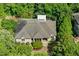 An aerial view of the brick home, highlighting its well-maintained roof and lush surroundings at 101 Cardiff Pl, Chapel Hill, NC 27516