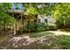 Backyard featuring wooden deck surrounded by lush foliage at 101 Cardiff Pl, Chapel Hill, NC 27516