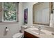 Bathroom features a toilet, wooden vanity with sink, and a gold trimmed mirror at 101 Cardiff Pl, Chapel Hill, NC 27516