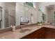 Bathroom vanity with double sinks, wooden cabinets, large mirror, and natural light at 101 Cardiff Pl, Chapel Hill, NC 27516