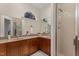 Bathroom vanity with double sinks, wooden cabinets, and a glass enclosed shower at 101 Cardiff Pl, Chapel Hill, NC 27516