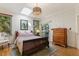 Bright bedroom with hardwood floors, a skylight, and access to a private balcony at 101 Cardiff Pl, Chapel Hill, NC 27516