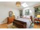 Bright bedroom features a skylight, hardwood floors, and a decorative chandelier at 101 Cardiff Pl, Chapel Hill, NC 27516