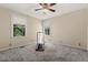 Bedroom with neutral walls, carpet, two windows, and an included treadmill at 101 Cardiff Pl, Chapel Hill, NC 27516