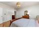 Bright bedroom features a decorative chandelier and hardwood floors at 101 Cardiff Pl, Chapel Hill, NC 27516