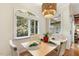 This bright dining room has a light fixture, window with blinds and wood floors at 101 Cardiff Pl, Chapel Hill, NC 27516