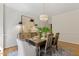 Bright dining room with hardwood floors, chandelier, and natural light, with simple, elegant decoration at 101 Cardiff Pl, Chapel Hill, NC 27516