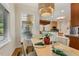 Bright dining area with wood floors, stylish light fixture, and large windows overlooking the backyard at 101 Cardiff Pl, Chapel Hill, NC 27516