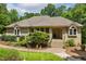 Inviting brick home with a lush front yard and attractive landscaping details at 101 Cardiff Pl, Chapel Hill, NC 27516