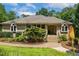 Stunning brick home boasts an inviting front yard with colorful Red Hot Poker flowers at 101 Cardiff Pl, Chapel Hill, NC 27516