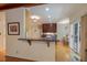 Kitchen with countertop bar open to the dining room has recessed lights and wood floors at 101 Cardiff Pl, Chapel Hill, NC 27516