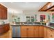 This kitchen is open to the breakfast nook and has a stainless steel dishwasher, wood cabinets and countertops at 101 Cardiff Pl, Chapel Hill, NC 27516