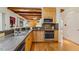 Modern kitchen with granite countertops, stainless steel appliances, and wooden cabinets at 101 Cardiff Pl, Chapel Hill, NC 27516