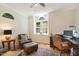 Comfortable living room featuring hardwood floors, classic furniture, natural lighting, and a ceiling fan at 101 Cardiff Pl, Chapel Hill, NC 27516