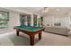 Inviting recreation room with pool table, a comfortable seating area and a view of the outdoors at 101 Cardiff Pl, Chapel Hill, NC 27516