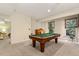 Bright living room featuring a pool table, natural light, and versatile layout at 101 Cardiff Pl, Chapel Hill, NC 27516