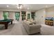 Inviting living room featuring a pool table, comfortable seating, and lots of natural light at 101 Cardiff Pl, Chapel Hill, NC 27516
