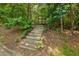 Wood stairway leads through the wooded area, suggesting a secluded and inviting outdoor space at 101 Cardiff Pl, Chapel Hill, NC 27516