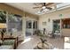 Sunny sunroom features a ceiling fan, skylights, and access to a patio with outdoor seating at 101 Cardiff Pl, Chapel Hill, NC 27516