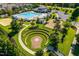 Aerial view of community pool, playground, amphitheater, and surrounding homes at 1019 Tranquil Crk Way, Wake Forest, NC 27587