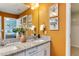 Stylish bathroom featuring double sinks with granite countertops, a large mirror, and warm lighting at 1019 Tranquil Crk Way, Wake Forest, NC 27587