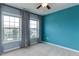 This bedroom boasts a vibrant accent wall, two bright windows and soft carpeting at 1019 Tranquil Crk Way, Wake Forest, NC 27587