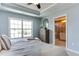 Bright bedroom with ensuite bath access, large windows, and neutral decor, offering a peaceful ambiance at 1019 Tranquil Crk Way, Wake Forest, NC 27587