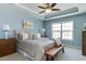 Airy bedroom with a tray ceiling, large windows, and calm blue walls for a relaxing retreat at 1019 Tranquil Crk Way, Wake Forest, NC 27587