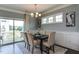 Dining area boasts natural light, modern chandelier, neutral decor, and convenient access to outdoor deck at 1019 Tranquil Crk Way, Wake Forest, NC 27587