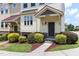 Close up of townhome with well-manicured landscaping and inviting entrance at 1019 Tranquil Crk Way, Wake Forest, NC 27587