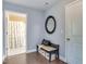 The hallway features hardwood floors, a cushioned bench and doorway leading to the bathroom at 1019 Tranquil Crk Way, Wake Forest, NC 27587