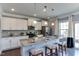 Modern kitchen with granite countertops, stainless steel appliances, and a breakfast bar at 1019 Tranquil Crk Way, Wake Forest, NC 27587