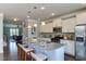 Open-concept kitchen featuring an island with seating, stainless appliances, and ample cabinet space at 1019 Tranquil Crk Way, Wake Forest, NC 27587