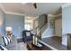 Inviting living room with hardwood floors, neutral walls, and staircase at 1019 Tranquil Crk Way, Wake Forest, NC 27587