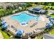 Aerial view of the community pool and clubhouse with sun loungers and cabanas at 1019 Tranquil Crk Way, Wake Forest, NC 27587