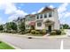 Street view of townhomes showcasing curb appeal with sidewalks and manicured lawns at 1019 Tranquil Crk Way, Wake Forest, NC 27587