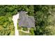 Aerial view of a brick home with mature trees and lush landscaping at 104 San Sophia Dr, Chapel Hill, NC 27514