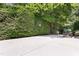 Concrete backyard with a basketball hoop attached to a mature landscaped privacy hedge at 104 San Sophia Dr, Chapel Hill, NC 27514