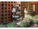 Backyard features a decorative water feature with a statue and flower garden at 104 San Sophia Dr, Chapel Hill, NC 27514