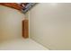 Unfinished basement with painted walls and floor, open ceiling and convenient wooden shelving at 104 San Sophia Dr, Chapel Hill, NC 27514