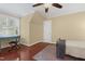 Bedroom featuring hardwood floors, a window with shutters, and a ceiling fan at 104 San Sophia Dr, Chapel Hill, NC 27514
