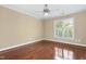 Empty bedroom with hardwood floors, a ceiling fan and a view through the window at 104 San Sophia Dr, Chapel Hill, NC 27514