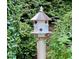 A decorative birdhouse is surrounded by plants at 104 San Sophia Dr, Chapel Hill, NC 27514