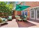 Outdoor deck with green patio umbrella, table, and chairs with lush backyard views at 104 San Sophia Dr, Chapel Hill, NC 27514