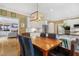 Bright dining area with a custom light fixture, hardwood floors, and access to the kitchen at 104 San Sophia Dr, Chapel Hill, NC 27514