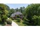 Beautifully landscaped brick home with mature trees and a circular driveway at 104 San Sophia Dr, Chapel Hill, NC 27514